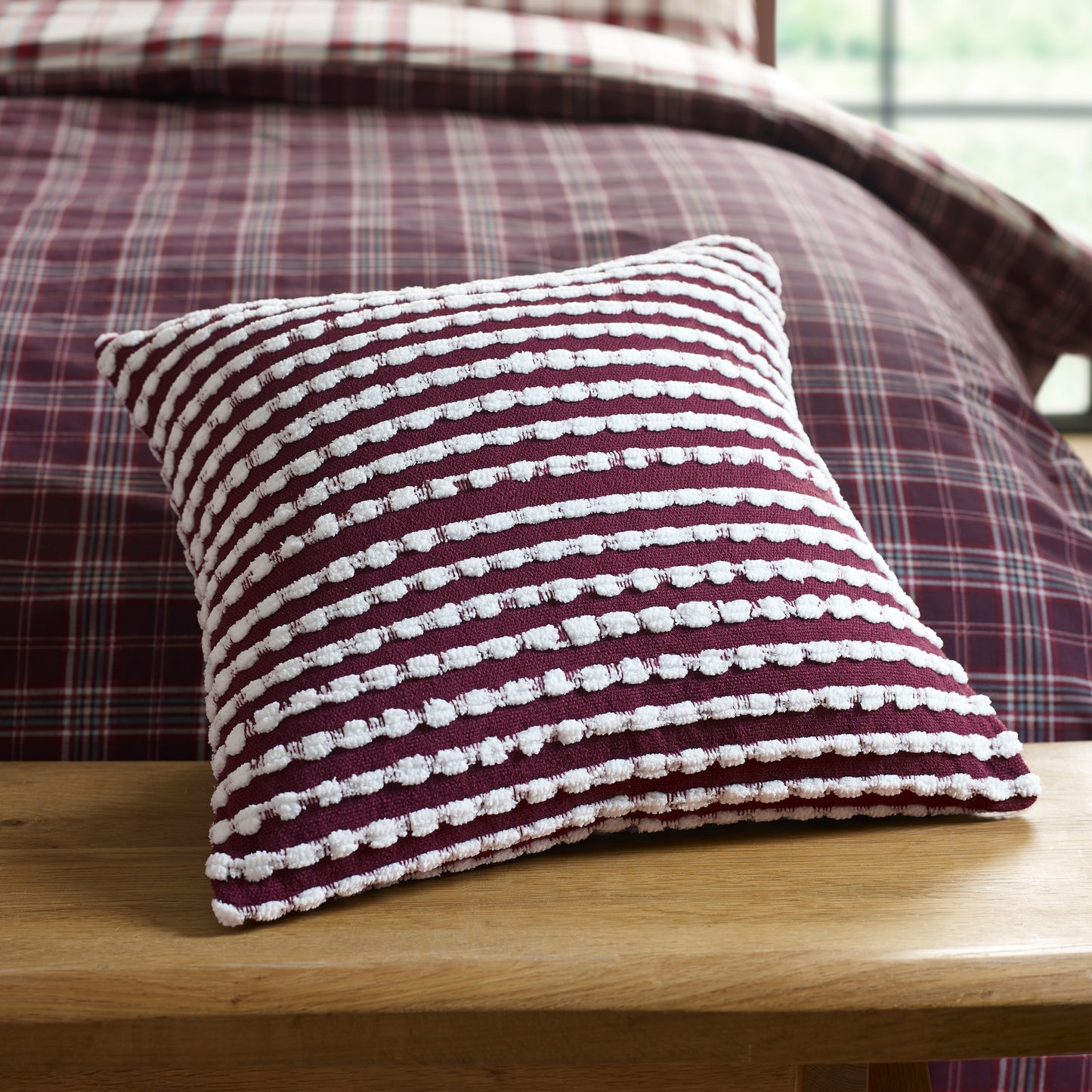 Stab Stitch Filled Cushion in Plum by Catherine Lansfield