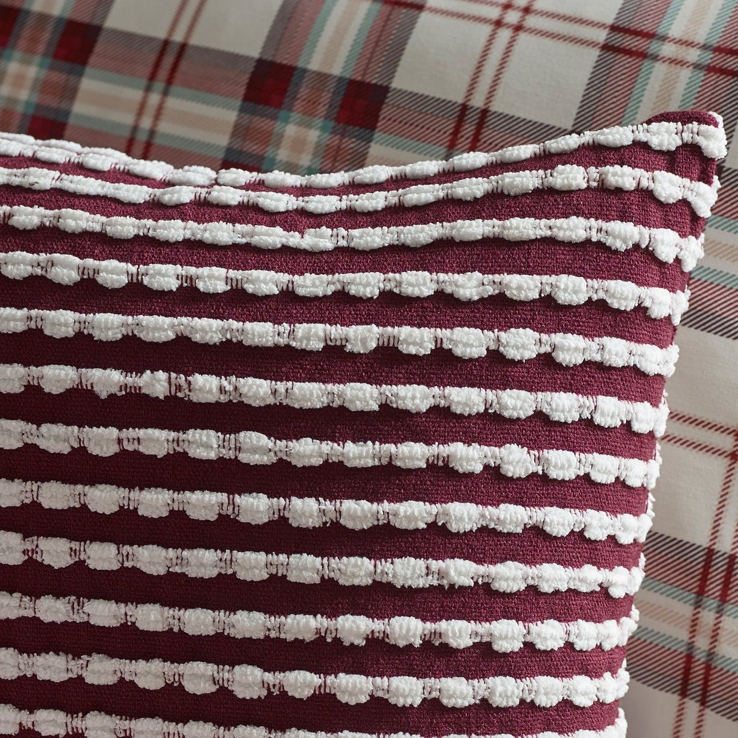 Stab Stitch Filled Cushion in Plum by Catherine Lansfield