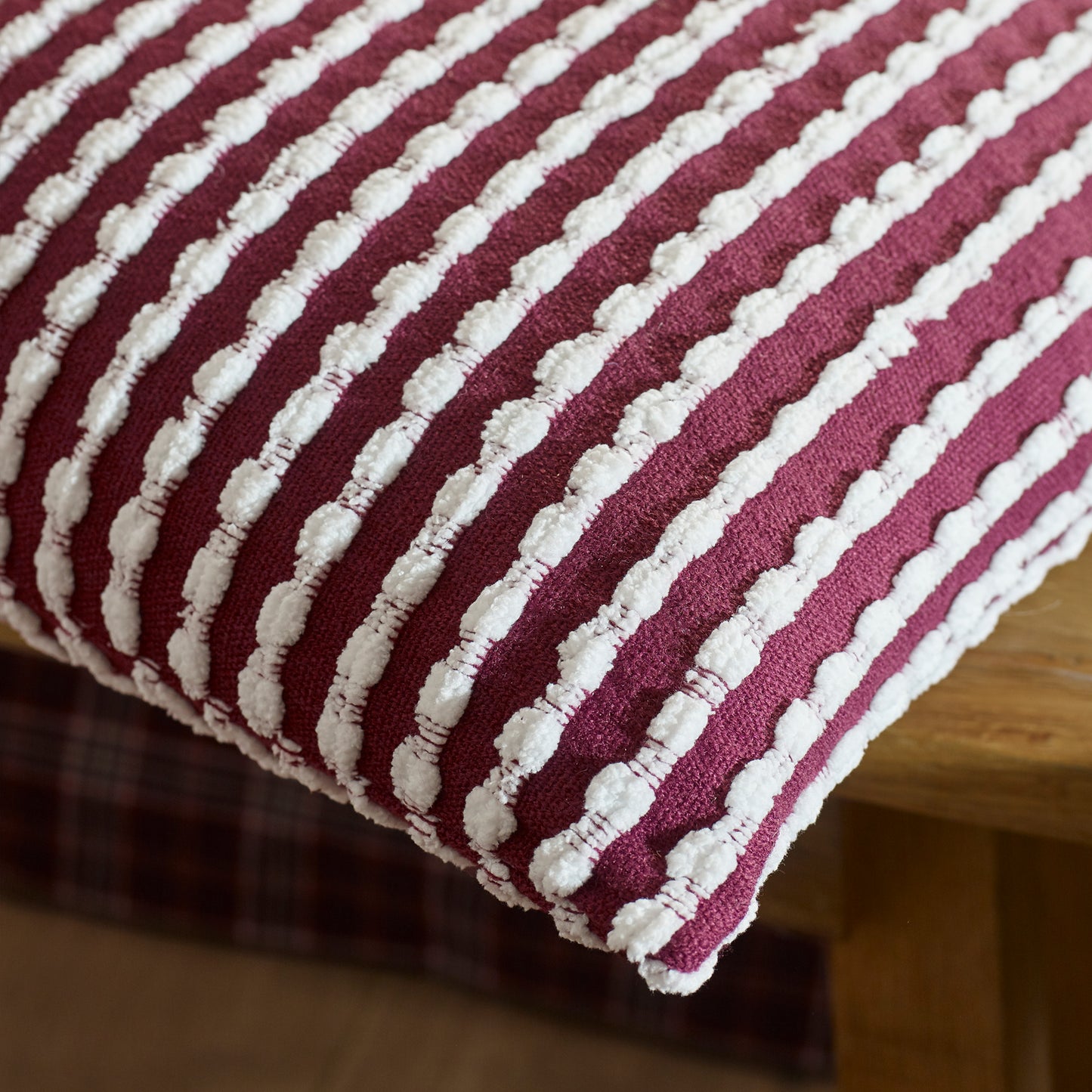 Stab Stitch Filled Cushion in Plum by Catherine Lansfield