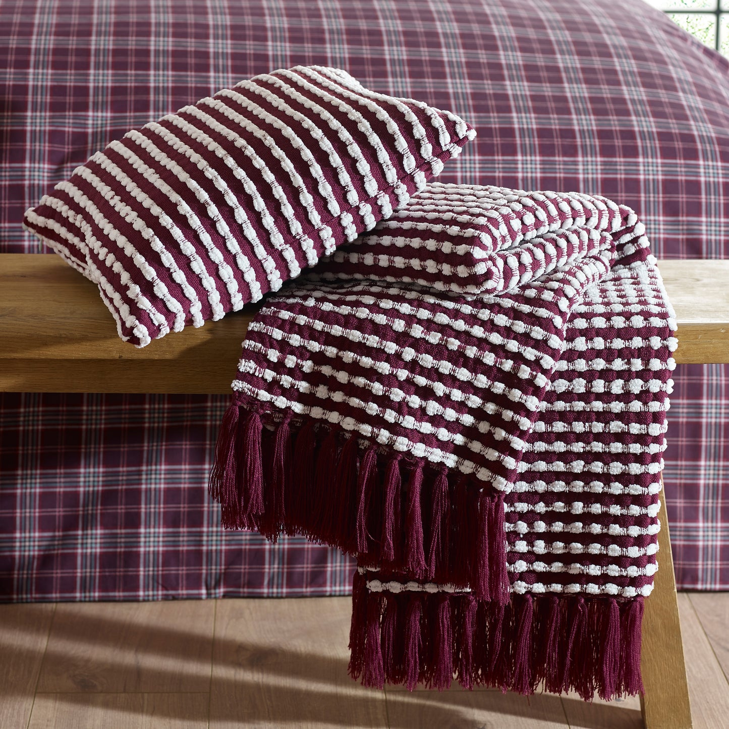 Stab Stitch Filled Cushion in Plum by Catherine Lansfield