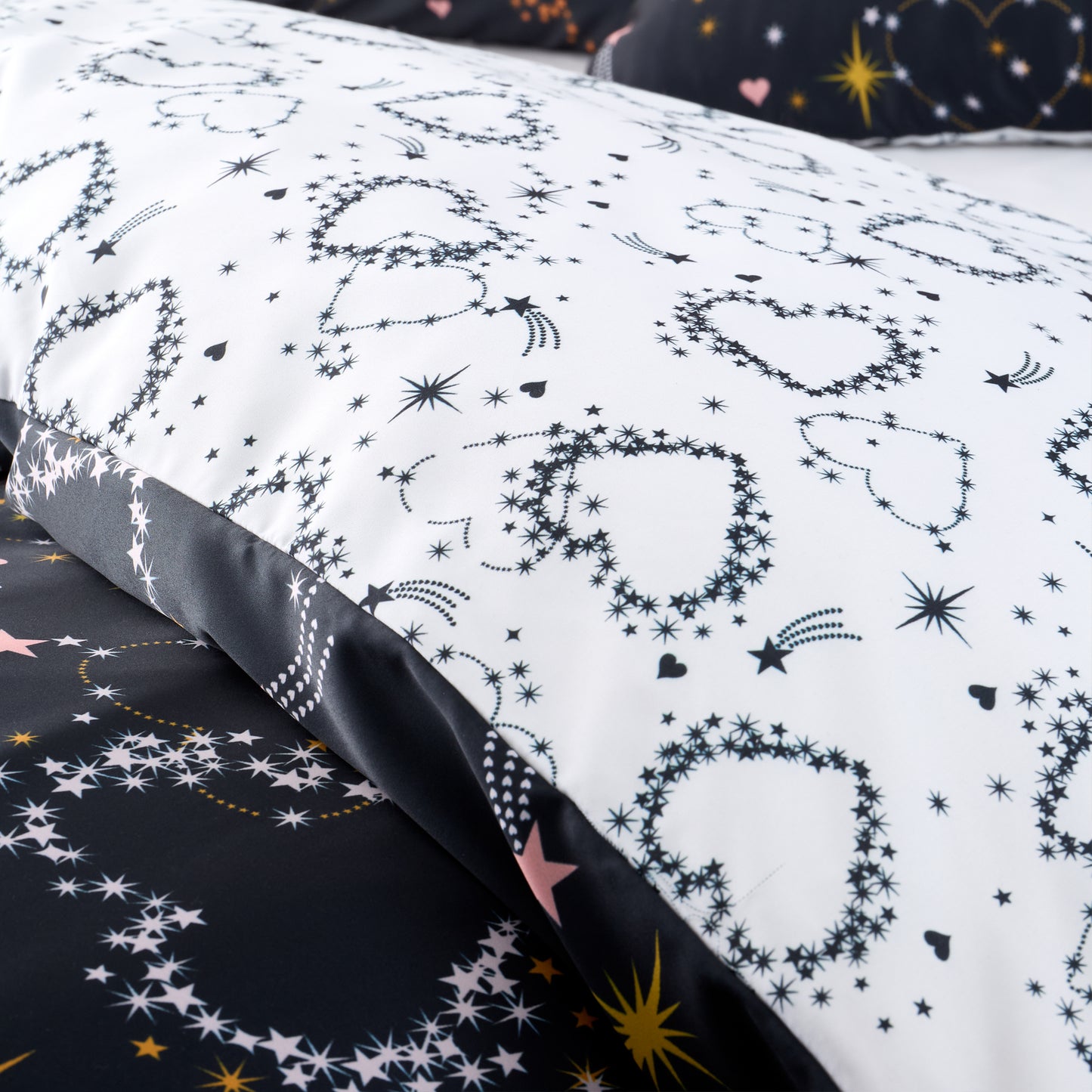 Cosmic Hearts and Stars Reversible Duvet Cover Set in Black by Catherine Lansfield