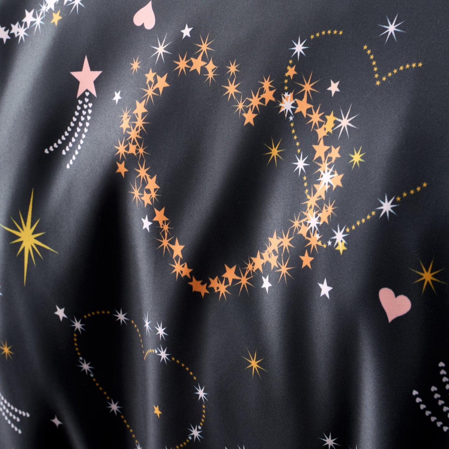 Cosmic Hearts and Stars Reversible Duvet Cover Set in Black by Catherine Lansfield